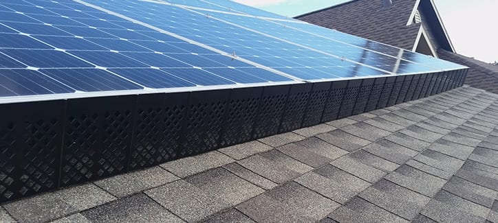 SolaTrim installed on a roof with solar panels.